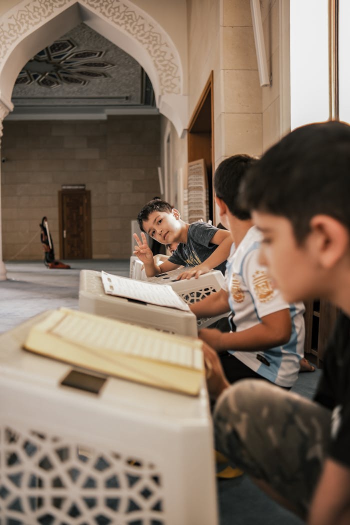 services-01 Children engaged in study inside a mosque, showcasing culture and learning.