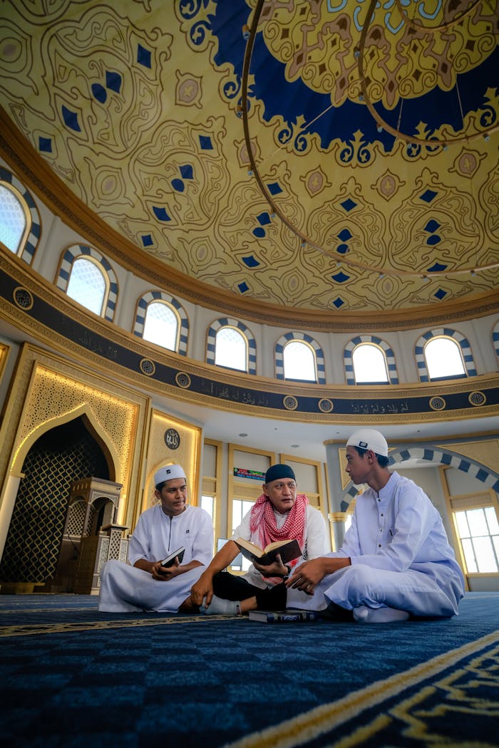 gallery-5 Three young men discuss religious texts under a mosque's ornate dome.